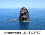 Rocks and cliffs at Madeira coastline. View from island at the Atlantic ocean. Vulcanic activity created high mountains like Pico de Ruivro and lava with clinkstone, whinstone and other igneous rocks.