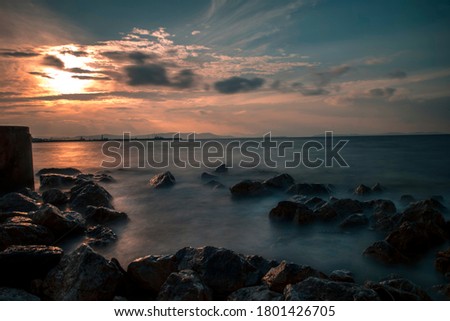 Rocks and clouds at the sunset