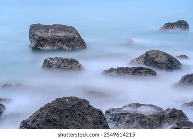 Rocks formation at the beach. Beautiful long exposure rocks in the sea - Powered by Shutterstock