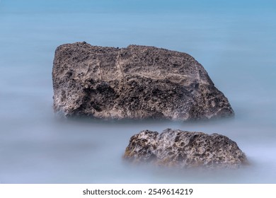 Rocks formation at the beach. Beautiful long exposure rocks in the sea - Powered by Shutterstock