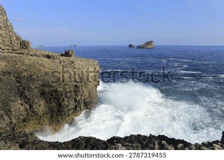 rocks hit by waves on the beach