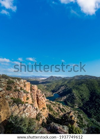 Rocks with layers, mountain range and dam