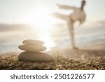 Rocks, pile and beach with man in zen for karate, martials arts training or taekwondo in nature. Closeup of stack or stones by ocean coast with male person in self defense for outdoor awareness