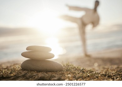 Rocks, pile and beach with man in zen for karate, martials arts training or taekwondo in nature. Closeup of stack or stones by ocean coast with male person in self defense for outdoor awareness - Powered by Shutterstock