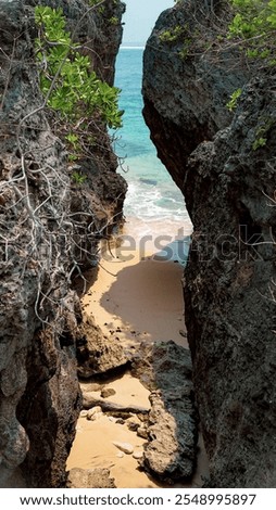 Rocks, sand and beach when sunset is falling in Geger Beach, Bali.