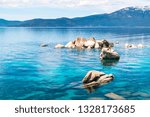 Rocks sticking out of the Gorgeous turquoise blue clear fresh waters of Lake Tahoe , California a refreshing natural wonder of the world in the Sierra Nevada mountains dramatic gorgeous landscape