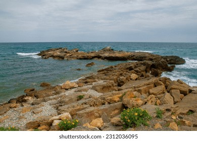 Rocks with stones near the sea in Spain in the region of Valencia - Shutterstock ID 2312036095