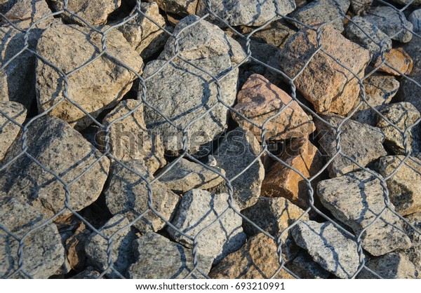 rocks and stones\
under the grid at the\
bridge