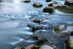 Rocks In Stream With Smooth Flowing Water