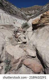 Rocks Tumbling Down A Cliff In A Desert.