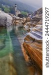 Rocks in the Verzasca River near the hamlet of Lavertezzo in the Valle Verzasca of Switzerland.“Amidst moss-kissed stones, an ancient church stands sentinel. Its tower reaches for the heavens.“