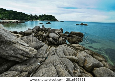 Rocks withstand the waves at the beach