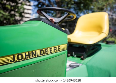 Rockville, MD / USA - June 2, 2019: A Motorcycle Repair Shop Has A Repaired John Deere Lawn Tractor Outside Of Its Facility On A Sunny Afternoon In The Summertime.