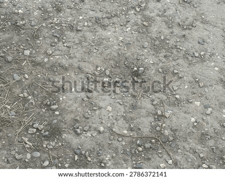 Rocky aggregate ground texture showcasing natural stone material in outdoor environment