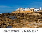 The rocky Atlantic coast and the fortified walls of the coastal city of Essaouira. Morocco, Africa