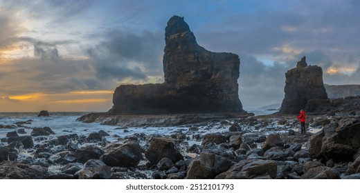 Rocky bay behind Talisker bay. Rock formations. Wild tide on rocky beach. Landscape photographer in red jacket. Isle of Skye on Scotland - Powered by Shutterstock