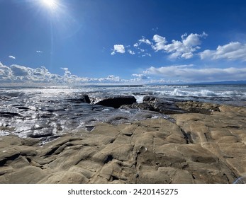 rocky beach, Landscape of a rocky shore surrounded by the sea on a sunny day. - Powered by Shutterstock