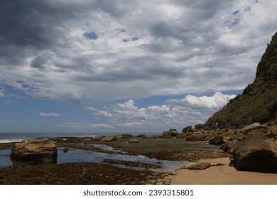 Rocky beach with large clouds