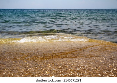 Rocky Beach On The Coast Of Greece. Blue Sea Water Horizon Line.