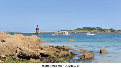 Rocky Beach  View With Boats And Beacon  Background In Aber Benoit, Brittany- France