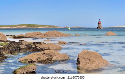 Rocky Beach  View With Boats And Beacon  Background In Aber Benoit, Brittany- France