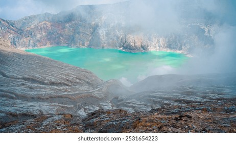 Rocky cliff at Ijen Crater volcano with a turquoise sulfuric lake. Popular tourist spot in East Java, Indonesia. Nature landscape background - Powered by Shutterstock