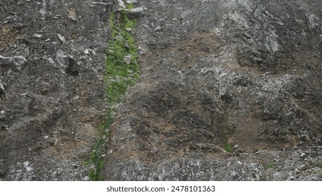 Rocky cliffs covered with a bit of moss at the bottom of the volcanic crater. - Powered by Shutterstock