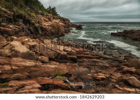 Rocky coast of the Atlantic Ocean. Gloomy weather. Acadia National Park. USA. Maine. Dramatic seascape.