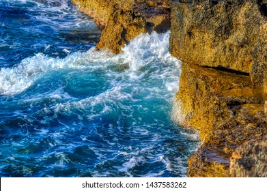 Rocky coast of Ayia Napa splashed by Mediterranean sea during summer day.