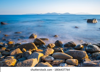 Rocky coast bay of mediterranean sea. Water on long exposure. Sunlight effect. Tourism and vacation, travelling concept. Geographic features banner. Italy, Piombino