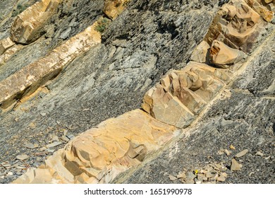 Rocky coast of Black Sea in village of Olginka, Tuapse district. Natural textures protruding on steep slopes of Caucasus Mountains. Close-up. Rock fragments and stones of different sizes as background - Powered by Shutterstock