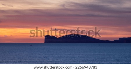 Rocky Coast by the Sea. Sardinia, Italy. Nature Background. Cloudy Sunset Sky. Panorama