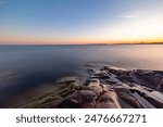 Rocky coast of the gulf of finland at sunset. Summer in Finland