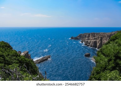 Rocky Coastline and Deep Blue Ocean with Clear Skies - Powered by Shutterstock