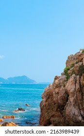 Rocky Coastline And Green Island In Shenzhen Bay, China