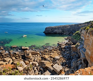 Rocky coastline,  ocean and sunlight shines through gaps in clouds. Beautiful nature background. - Powered by Shutterstock