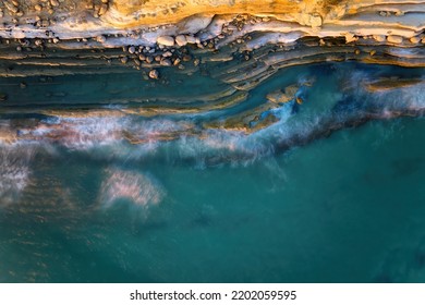 Rocky Coastline, Perpendicular View Of The Shore, Long Exposure, Blurred Waves.  Wild Coast, Illuminated By The Pink Light Of The Setting Sun, Albania.