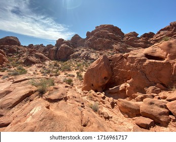 Rocky Desert Landscape With Desert Brush And Clear Blue Sky