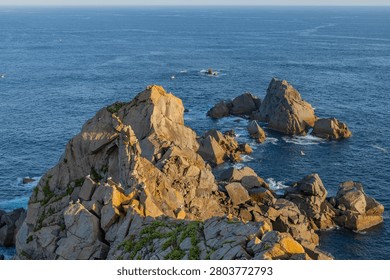 Rocky headland with dramatic cliffs and Atlantic waves in Estaca de Bares. Galicia, Spain