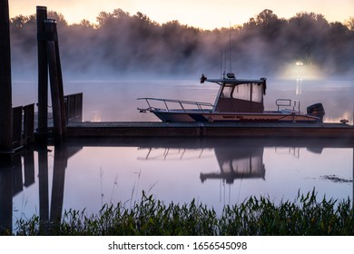 Rocky Hill, CT, USA - October 05 2019 - Ferry Park. Rocky Hill Municipal rescue boat sits on the Connecticut River in the early morning with Fog in the background.