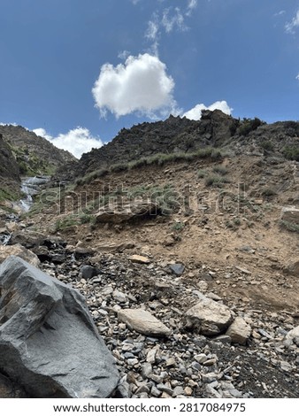 Rocky hillside with sparse vegetation