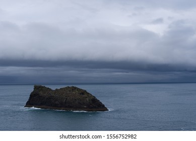 Rocky island off the Cornwall Coast with birds and a storm rolling in off the sea. - Shutterstock ID 1556752982