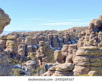 A rocky landscape image of the rock formations inside Chiricahua National Monument hiking area. This clear day shows off the different natural geological spires of stone in the wintertime. - Powered by Shutterstock