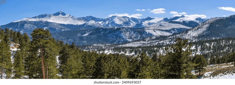 Rocky Mountain National Park - A panoramic view of snow-capped northern Front Range mountains, leading by majestic Longs Peak at left, on a sunny Spring day. Rocky Mountain National Park, Colorado, US - Powered by Shutterstock