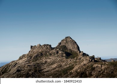 Rocky mountain peak at a mountain ridge under a clear blue sky
