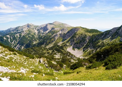 Rocky mountain peaks in the Julian Alps in Slovenia near the Vogel hill. Summer mountains and landscape over Lake Bohinj.