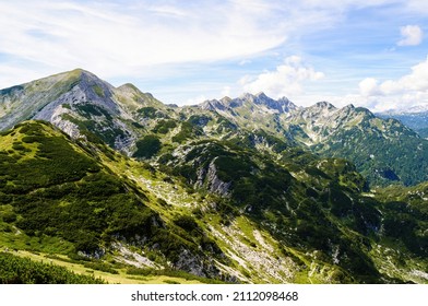 Rocky mountain peaks in the Julian Alps in Slovenia near the Vogel hill. Summer mountains and landscape over Lake Bohinj.