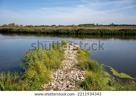 rocky non-submerged river spur dike at the Warta river near Osiecza I in Greater Poland Province, Poland