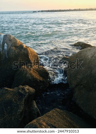 Rocky ocean edge with an island in the distance