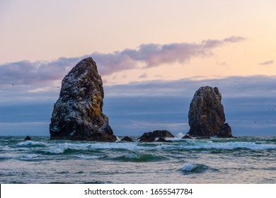 Rocky Outrcrops As Birds Islands Near The Haystack Rock At Dusk Or Sunset, Cannon Beach, Oregon Coast Scenery, US Route 101, OR, USA.